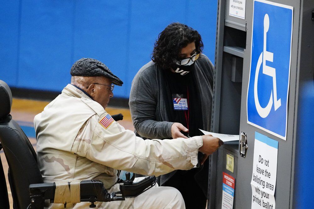 A voter casts his ballot in Georgia's Senate runoff election on Tuesday